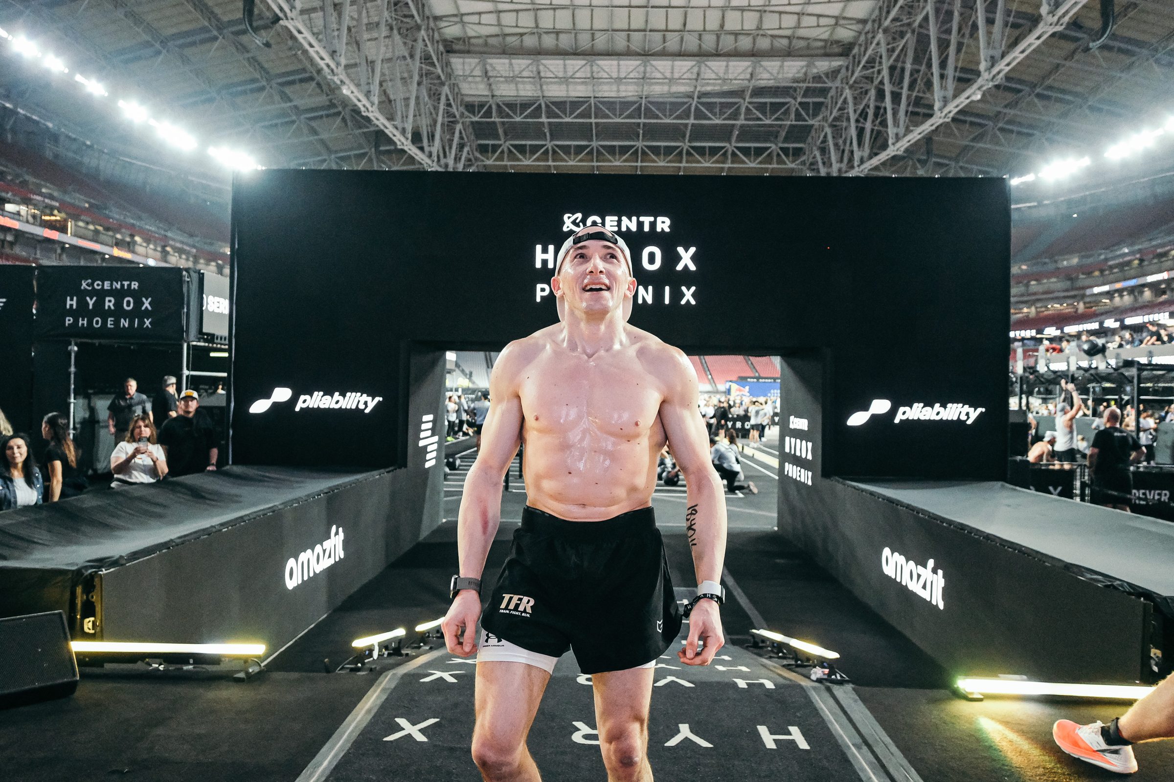 Adam coming through the finish chute at HYROX Phoenix, State Farm Stadium
